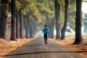 Women running on open road.